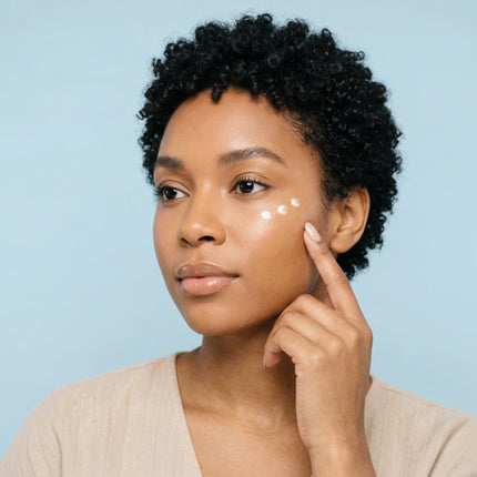 Lady adding eye cream on her skin